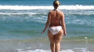 Hot thick blonde girl. Bikini beach.