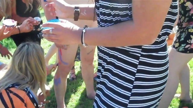 clothed girls do hand painting on a naked guy CFNM